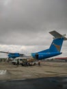 Dar es Salaam, Tanzania - December 5, 2019: baggage is unloaded from the helicopter at the airport. Airplane coloring in national Royalty Free Stock Photo