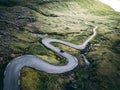 Aerial View of Car Tackling Faroe Islands' Serpentine Roads Royalty Free Stock Photo