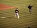 Daric Barton and Umpire run for ball Royalty Free Stock Photo