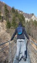 daring boy does balance exercises over the Tibetan bridge suspen