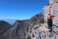 A daring European tourist rock climbing in Cape Town South Africa with all gears