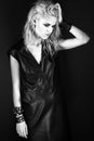 Daring girl model in black leather dress, style of