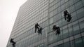 Window cleaners hanging from a high rise building