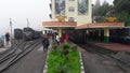 Darjeeling railway station with tourists, toy trains, and porter and toy train track