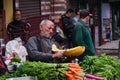 Darjeeling, West Bengal, India. June 22, 2022. A village man sitting on the road side of a busy area in darjeeling for sell his