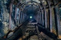 Dark abandoned coal mine with rusty miner stands