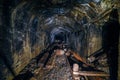 Dark abandoned coal mine with rusty remnants of equipment Royalty Free Stock Photo