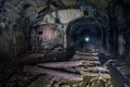 Dark abandoned coal mine with rusty remnants of equipment Royalty Free Stock Photo