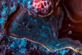 Dark abstract macro photograph of liquid with deep textures and glowing blue and red accents. Suitable for dramatic Royalty Free Stock Photo