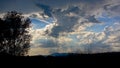 Dark cloudy sky in the evening light over silhouette of Romanian mountains