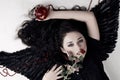 Dark angel girl with a red apple and rose Royalty Free Stock Photo