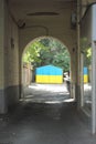 Dark arch into the courtyard with the light at the end of the arch Royalty Free Stock Photo