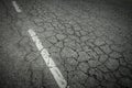 Dark asphalt road with cracks. Background texture