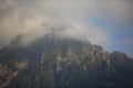 Dark atmospheric surreal landscape with a dark rocky mountain peak Royalty Free Stock Photo