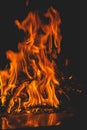 Dark background bonfire from branches in the fireplace . flame and sparks Royalty Free Stock Photo