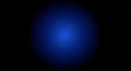 Dark background with a bright, glowing blue circular gradient light effect Royalty Free Stock Photo