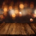 Celebratory bokeh background with wooden table Royalty Free Stock Photo