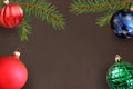 Dark background with Christmas fir branch, red wavy dull, green and blue ball Royalty Free Stock Photo