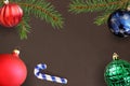 Dark background with Christmas fir branch, stick, red wavy, green ribbed and blue ball Royalty Free Stock Photo