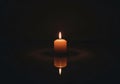 Dark background emphasizes the candle\'s light, casting a soft Royalty Free Stock Photo
