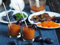 Dark background with glasses of orange juice on a blue napkin.Juice or smoothie made from natural plum with ingredients