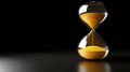 A dark background sets the scene for a classic hourglass, its flowing sand a reflection of time Royalty Free Stock Photo