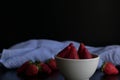 Strawberry white bowl photo with dark background Royalty Free Stock Photo