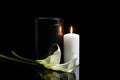 Mortuary urn, burning candle and flowers on dark background Royalty Free Stock Photo