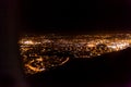 Dark background view of city with lights from aeroplane. Night lights in the city. Aeroplane view of dark nigh above the