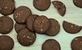 Dark baked chocolate cookies on gray wooden board, table. Top view. Food photography. Royalty Free Stock Photo