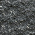 Dark basalt rock texture with a rough surface, featuring irregular patterns of white Royalty Free Stock Photo