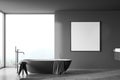 Dark bathroom interior with bathtub and window, table with towels. Mockup poster