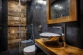 Dark bathroom interior with shower. Tiles imitating wood on the floor and on the wall