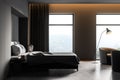 Dark bedroom interior with bed with armchairs on concrete floor near window Royalty Free Stock Photo