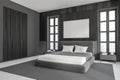 Dark bedroom interior with empty white poster, bed, panoramic window Royalty Free Stock Photo