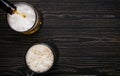 Dark beer, ale or stout is poured into glass, dark wooden bar counter, space for text, top view Royalty Free Stock Photo