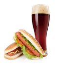 Dark beer glass and two hot dogs with various ingredients Royalty Free Stock Photo