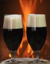 Dark Beer glasses before the cozy firepace in country house