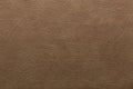 Dark beige faux leather with crumpled embossing. Texture for background and design.