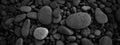 Dark black abstract smooth round pebbles sea texture background Royalty Free Stock Photo