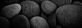 Dark black abstract smooth round pebbles texture background