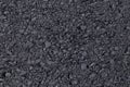 Dark black background from adjoined rolled asphalt. Modern technologies of solid pavement for vehicles and pedestrians. Elements