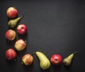 On a dark black background red yellow green apples pear frame top view flat lay Royalty Free Stock Photo