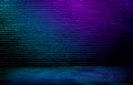 dark black brick wall background, rough concrete and plastered concrete floor, with gradient neon blue and purple glowing lights Royalty Free Stock Photo