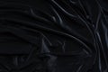 Dark black velvet fabric, wave, draperies. Beautiful textile backdrop. Close-up. Top view Royalty Free Stock Photo