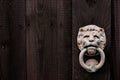 Dark black wooden background with lion shaped door knocker and s Royalty Free Stock Photo