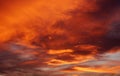 Dark blood red sky background. Dramatic heavy clouds with the hint of the sun at sunset. Royalty Free Stock Photo