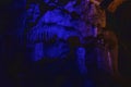 Dark blue abstract background of stalactites, stalagmites and stalagnates in the Sfendoni cave, underground,. horizontal