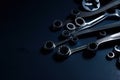 dark blue backdrop with metal object, such as wrench or socket set