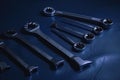 dark blue backdrop with metal object, such as wrench or socket set